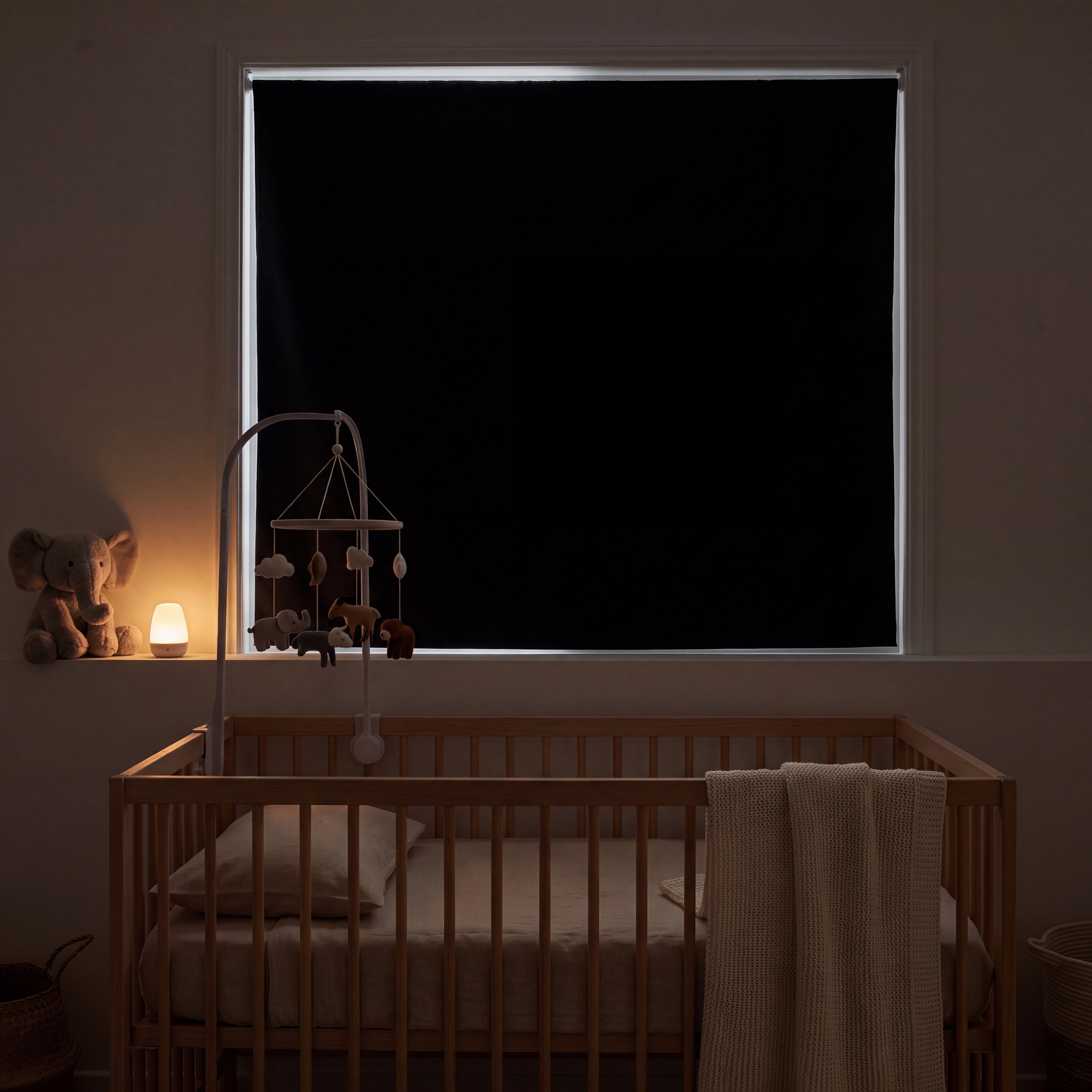 Dark calm nursery at nap time with the blackout panel covering the window